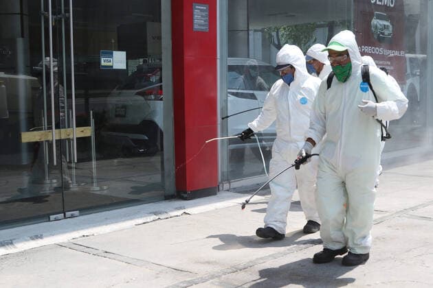 Mexico: Coronavirus prevention Health worker wears protective gear while spraying disinfectant solution on the ground outside the Buenavista train station as a measure security to combat the spread of the SARS COV-2 which causes the disease COVID-19. For editorial use only. Please contact your Local office representative for commercial use. **Mandatory Credit** Mexico City Mexico Copyright: IsmaelxRosas