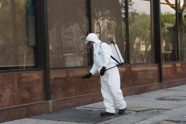 Mexico: Coronavirus prevention Health worker wears protective gear while spraying disinfectant solution on the ground outside the Buenavista train station as a measure security to combat the spread of the SARS COV-2 which causes the disease COVID-19. For editorial use only. Please contact your Local office representative for commercial use. **Mandatory Credit** Mexico City Mexico Copyright: IsmaelxRosas
