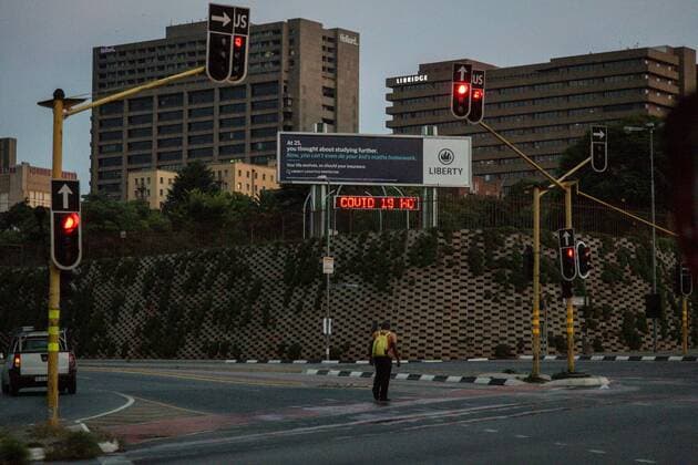 (200411) -- JOHANNESBURG, April 11, 2020 (Xinhua) -- Photo taken on April 10, 2020 shows a man crossing an empty street in Johannesburg, South Africa. South African President Cyril Ramaphosa on Thursday announced that the country s lockdown aimed at stemming the spread of COVID-19 would be extended for another two weeks. (Photo by Yeshiel Xinhua) SOUTH AFRICA-JOHANNESBURG-COVID-19 