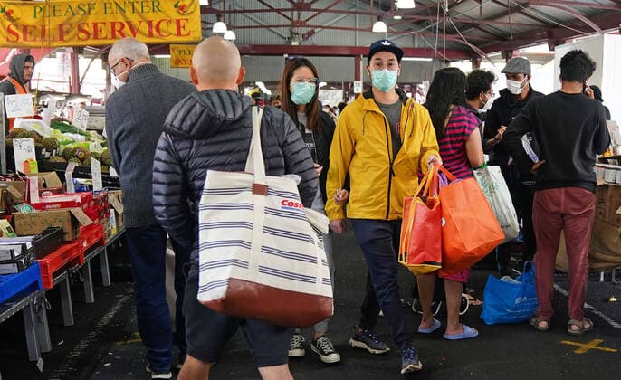 AUSTRALIA CORONAVIRUS COVID-19, People shop at the Queen Victoria Market while wearing face masks as a preventive measure against the spread of novel coronavirus COVID-19 in Melbourne, Saturday, April 11, 2020. Authorities have said social distancing and isolation measures could still remain in place for the next six months. A shutdown of non-essential services is in effect Australia wide in a bid to slow the spread of the coronavirus (COVID-19) disease. ( NO ARCHIVING, EDITORIAL USE ONLY, NO USE IN BOOKS WITHOUT CONSENT MELBOURNE VIC AUSTRALIA  Copyright: xSCOTTxBARBOURx 20200411001463004809