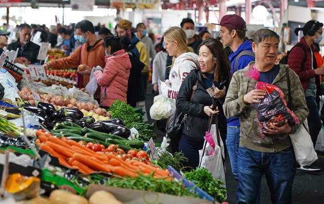 AUSTRALIA CORONAVIRUS COVID-19, People shop at the Queen Victoria Market while wearing face masks as a preventive measure against the spread of novel coronavirus COVID-19 in Melbourne, Saturday, April 11, 2020. Authorities have said social distancing and isolation measures could still remain in place for the next six months. A shutdown of non-essential services is in effect Australia wide in a bid to slow the spread of the coronavirus (COVID-19) disease. ( NO ARCHIVING, EDITORIAL USE ONLY, NO USE IN BOOKS WITHOUT CONSENT MELBOURNE VIC AUSTRALIA  Copyright: xSCOTTxBARBOURx 20200411001463005801