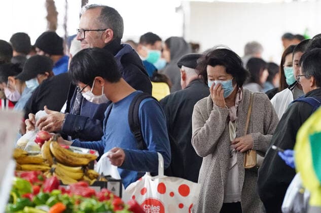 AUSTRALIA CORONAVIRUS COVID-19, People shop at the Queen Victoria Market while wearing face masks as a preventive measure against the spread of novel coronavirus COVID-19 in Melbourne, Saturday, April 11, 2020. Authorities have said social distancing and isolation measures could still remain in place for the next six months. A shutdown of non-essential services is in effect Australia wide in a bid to slow the spread of the coronavirus (COVID-19) disease. ( NO ARCHIVING, EDITORIAL USE ONLY, NO USE IN BOOKS WITHOUT CONSENT MELBOURNE VIC AUSTRALIA  Copyright: xSCOTTxBARBOURx 20200411001463006492