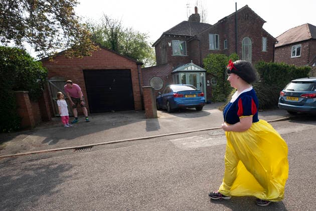 (200411) -- STOCKPORT, April 11, 2020 -- Rebecca Williamson, a girl dressed in Snow White costumes, cheers up people amid the COVID-19 pandemic in Stockport near Manchester, Britain, on April 10, 2020. Rebecca, one of those who dressed as comic books or fairytale characters, attempted to cheer up people in the public during the epidemic outbreak. (Photo by Xinhua) UK-STOCKPORT-COVID-19-SNOW WHITE JonxSuper 