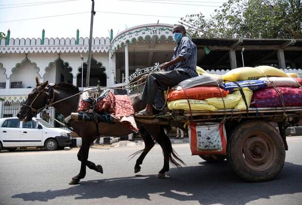 April 11, 2020, Guwahati, Assam, India: Horse cart with essentials passing in front of Athgaon Kabaristan Masjid, during the nationwide lockdown to curb the spread of coronavirus, in Guwahati. The area has been identified as a COVID-19 hotspot. Guwahati India - ZUMAt232 20200411_zip_t232_004 Copyright: xDavidxTalukdarx