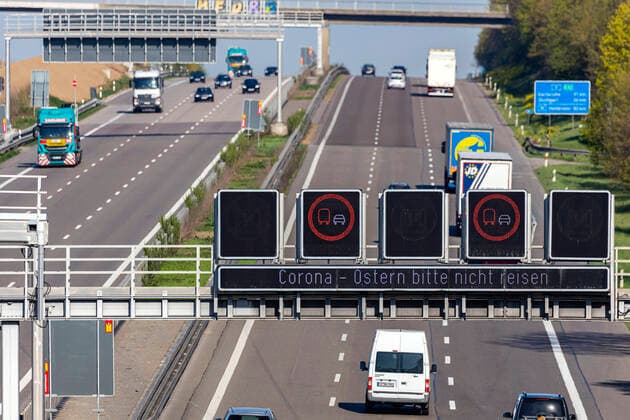 DEU, Deutschland, Baden-Württemberg, Stuttgart, 11.04.2020: Autobahn A8 bei Stuttgart in Zeiten der Corona-Pandemie. Es sind nur wenige Fahrzeuge unterwegs. Ein LED Wechselverkehrszeichen mahnt zum Kontaktverzicht: Corona - Ostern bitte nicht reisen.