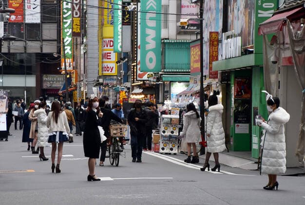 Waitresses wearing maid costumes and face masks wait at street at Akihabara shopping district in Tokyo, Japan on Saturday, on April 11, 2020.  TKP2020041115 KEIZOxMORI