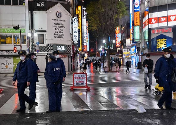 Members of Tokyo Metropolitan Police Department stand guard at Kabukicho shopping and entertainment district in Tokyo, Japan on Saturday evening, April 11, 2020.  TKP2020041127 KEIZOxMORI