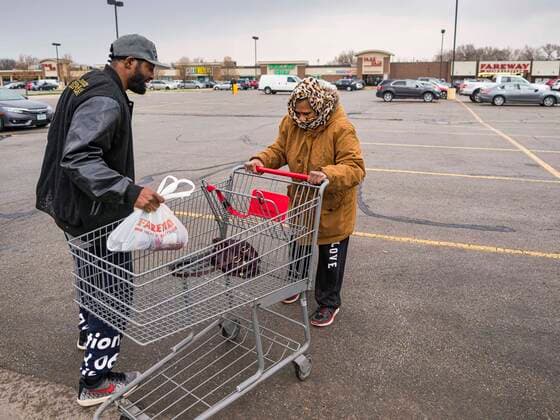 April 11, 2020, Des Moines, Iowa, U.S: People pick up a ready to cook pasta meal at a food distribution in Des Moines. Most non-essential businesses in Iowa are closed until 30 April. Because of business closings causes by the Novel Coronavirus (SARS-CoV-2) pandemic, well over 100,000 Iowans filed first time claims for unemployment in the last three weeks, more than applied during the peak of the Great Recession of 2008. Local food banks have seen an unprecedented spike in people seeking nutritional assistance. Midwest Foods, a Des Moines based company and owner of Ginos Fine Italian Foods, gave away 1,000 complete dinners with sauce, noodles, salad, and dressing Saturday morning. People started lining up 3 hours before the food distribution began. The food distribution was done following social distancing guidelines and all of the wo - ZUMAk94_ 20200411_zaf_k94_013 Copyright: xJackxKurtzx