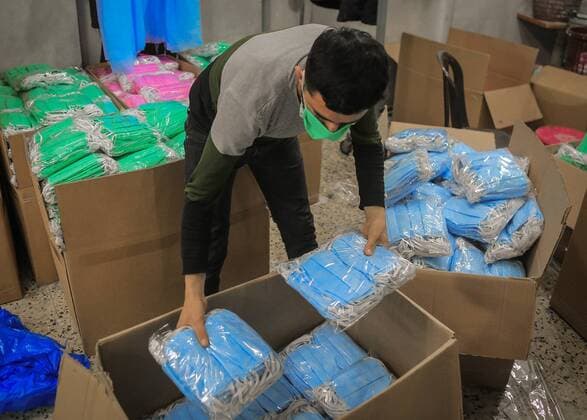 April 11, 2020, Gaza City, The Gaza Strip, Palestine: Palestinian worker at Gaza city make protective face masks to be exported and sold in US and Europe. Gaza City Palestine - ZUMAq100 20200411_zaa_q100_038 Copyright: xAbedxAlrahmanxAlkahloutx