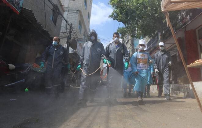 April 11, 2020, Dair Al Balah, Gaza Strip: Palestinian workers spray disinfectant as a preventive measure amid fears of the spread of the coronavirus disease (COVID-19), in Dair Al Balah in the center of Gaza strip. Dair Al Balah Palestinian Territory - ZUMAap3_ 20200411_zaf_ap3_084 Copyright: xAshrafxAmrax