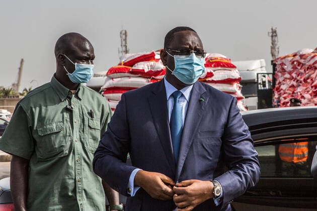 Coronavirus in Senegal, Präsident Macky Sall startet Hilfslieferungen (200412) -- DAKAR, April 12, 2020 (Xinhua) -- Senegalese president Macky Sall (R) arrives at the Dakar Autonomous Port in Dakar, Senegal, April 11, 2020. Senegalese President Macky Sall launched Saturday a food delivery operation in the regions at the Dakar Autonomous Port as part of assistance to households affected by COVID-19. Sall initiated the emergency food aid program with a budget of 69 billion Francs CFA (about 114 million U.S. dollars), which is drawn from the response and solidarity fund against the effects of COVID-19 for the purchase of 146,000 tonnes of food to distribute to targeted households across the country. (Photo by Eddy Peters Xinhua) SENEGAL-DAKAR-COVID-19-FOOD AID 