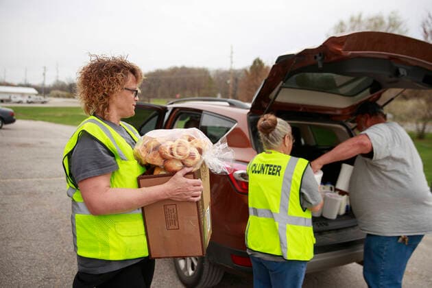 April 11, 2020, Ellettsville, Indiana, United States: Volunteers at Pantry 279 distribute food to area residents experiencing food insecurity during the COVID-19 Coronavirus emergency... The pantry nearly ran out of food after more than 600 people, from 179 different families, came seeking food last Wednesday, but last minute trips to local grocery stores, some people dropping off food donations, and a last minute shipment of produce helped keep the pantry in stock. Ellettsville United States - ZUMAs197 20200411_zaa_s197_159 Copyright: xJeremyxHoganx