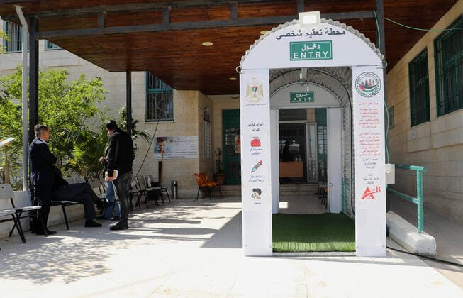 April 12, 2020, Al-Eizariya, Jerusalem, Palestinian Territory: Palestinians stand inside a sterilization chamber set up at al-Eizariya village, East Jerusalem a precaution against the spread of coronavirus disease (COVID-19), at a restaurant in Gaza city, on April 12, 2020 Al-Eizariya Palestinian Territory - ZUMAap3_ 20200412_zaf_ap3_064 Copyright: xMuhammedxQaroutxIdkaidekx