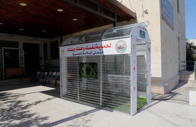 April 12, 2020, Al-Eizariya, Jerusalem, Palestinian Territory: Palestinians stand inside a sterilization chamber set up at al-Eizariya village, East Jerusalem a precaution against the spread of coronavirus disease (COVID-19), at a restaurant in Gaza city, on April 12, 2020 Al-Eizariya Palestinian Territory - ZUMAap3_ 20200412_zaf_ap3_065 Copyright: xMuhammedxQaroutxIdkaidekx