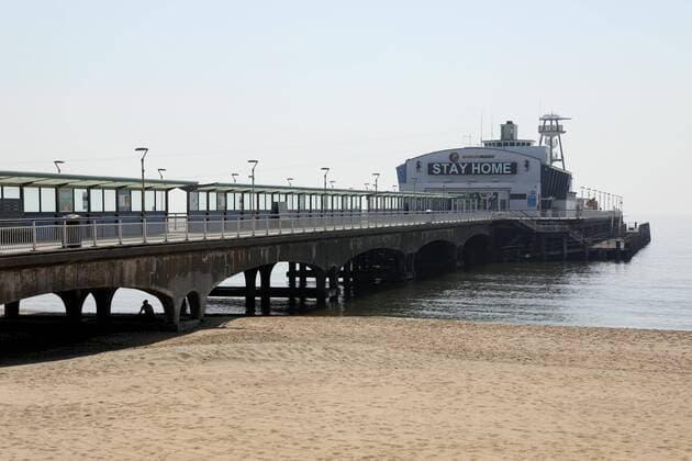 (200412) -- BOURNEMOUTH, April 12, 2020 (Xinhua) -- A sign on Bournemouth Pier encouraging people to stay at home is seen in Bournemouth, Britain on April 11, 2020. (Photo by Tim Ireland Xinhua) BRITAIN-BOURNEMOUTH-COVID-19-BEACH 