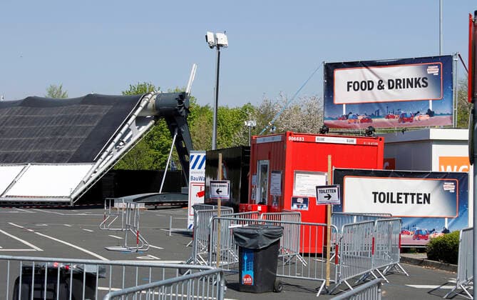 12.04.2020, Katholische Ostermesse im Autokino Düsseldorf, li: heruntergeklappte Kinoleinwand, re: Container mit Speisenverkauf und Toiletten. 12.04.2020, Katholische Ostermesse im Autokino Düsseldorf 12.04.2020, Katholische Ostermesse im Autokino Düsseldorf