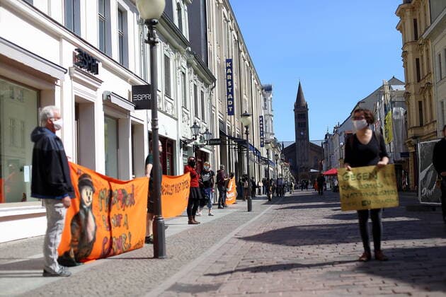 Menschen bilden in der Brandenburger Straße eine Menschenkette und fordern angesichts der Ausbreitung des Coronavirus die Evakuierung griechischer Flüchtlingslager, Potsdam, 12. April 2020. Leave No One Behind Menschenkette in Potsdam