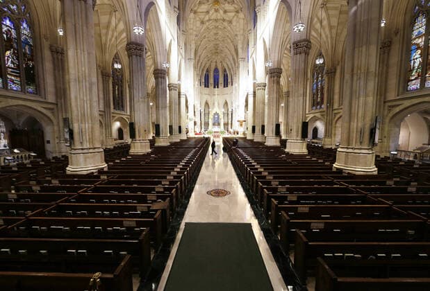 Church pews are empty of parishioners due to the Coronavirus pandemic while Cardinal Timothy Dolan offers Easter Sunday Mass at St. Patrick s Cathedral in New York City on Sunday, April 12, 2020. For the first time, the United States government and President Trump have declared all 50 states a major disaster for the same event.  NYP20200412104 JOHNxANGELILLO