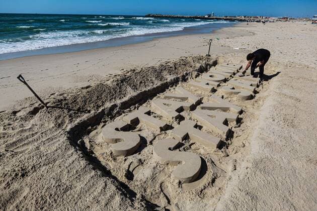 (200412) -- GAZA, April 12, 2020 (Xinhua) -- A Palestinian artist carves words STAY HOME STAY SAFE with sand on a beach in Gaza City, on April 12, 2020. Palestine said on Sunday that the total number of COVID-19 cases in the country has reached 290. (Photo by Rizek Abdeljawad Xinhua) MIDEAST-GAZA CITY-COVID-19-SAND ART 