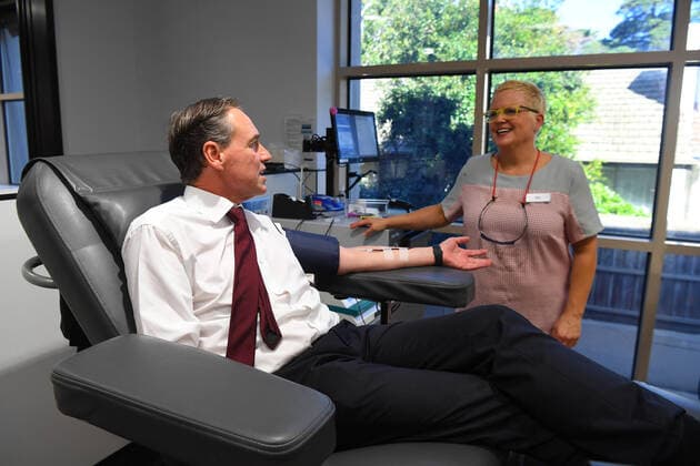 GREG HUNT CORONAVIRUS PRESSER, Australian Health Minister Greg Hunt (left) donates blood at the Lifeblood Donor Centre in Frankston, Melbourne, Monday, April 13, 2020. The Minister for Health, Greg Hunt has announced the Australian Government will provide a further $3 million to boost the nationally coordinated emergency response to the COVID-19 outbreak. ( NO ARCHIVING, EDITORIAL USE ONLY, NO USE IN BOOKS WITHOUT CONSENT MELBOURNE VIC AUSTRALIA  Copyright: xJAMESxROSSx 20200413001463263938