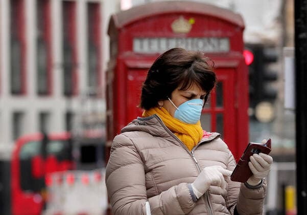 (200413) -- LONDON, April 13, 2020 (Xinhua) -- A woman wearing a mask waits for a bus on Shaftesbury Avenue in London, Britain, April 13, 2020. The death toll of those hospitalized in Britain who tested positive for the novel coronavirus reached 10,612 as of Saturday afternoon, the Department of Health and Social Care said Sunday. (Photo by Tim Ireland Xinhua) BRITAIN-LONDON-COVID-19-DEATH TOLL 