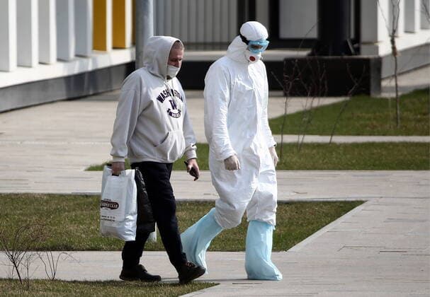 MOSCOW, RUSSIA - APRIL 13, 2020: A paramedic in protective gear and a patient at the Novomoskovsky multipurpose medical center for patients with suspected COVID-19 coronavirus infection. Valery Sharifulin TASS  TS0D58F1