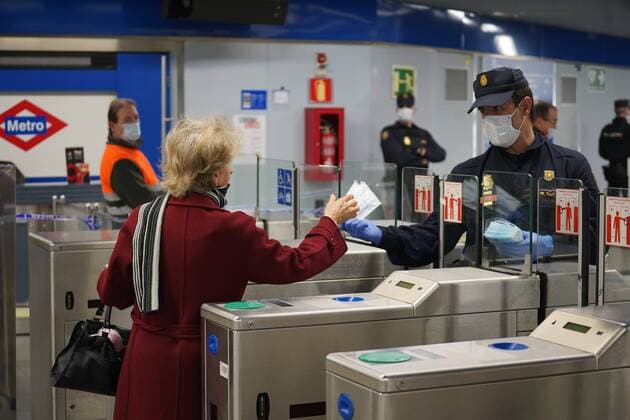 A police officer gives out free protective face masks during the lockdown amid the coronavirus disease COVID 19 outbreak in Madrid, Spain, April 13, 2020 Cordon Press
