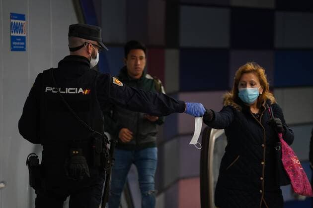 A police officer gives out free protective face masks during the lockdown amid the coronavirus disease COVID 19 outbreak in Madrid, Spain, April 13, 2020 Cordon Press