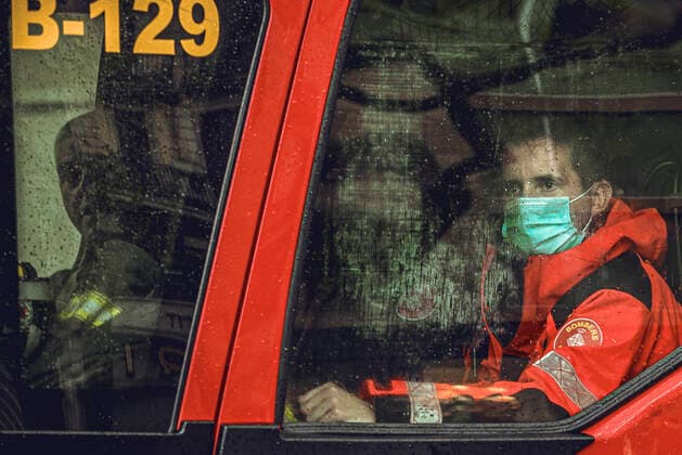 April 13, 2020, Barcelona, Catalonia, Spain: Members of Barcelona s municipal fire and rescue service are seen through a rainy window at Easter Monday after more than one month of a nationwide lockdown due to the continuous spread of the virus. Spain registered roughly 300 new fatalities summing up to nearly 17500 in total. Barcelona Spain - ZUMAo105 20200413_zap_o105_004 Copyright: xMatthiasxOesterlex