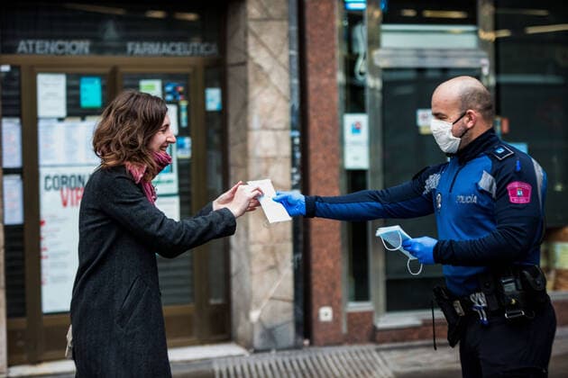 April 13, 2020, Madrid, Spain: A Spanish police officer distributes face masks at the Embajadores Station in Madrid..Some companies were set to resume operations at the end of the two-week halt of all non-essential activities amid a national lockdown to stop the spread of the COVID-19 coronavirus. More than 15,000 people are reported to have died in Spain due to the COVID-19 outbreak, although the country has reported a decline in the daily number of deaths. Madrid Spain - ZUMAs197 20200413_zaa_s197_058 Copyright: xBraisxG.xRoucox