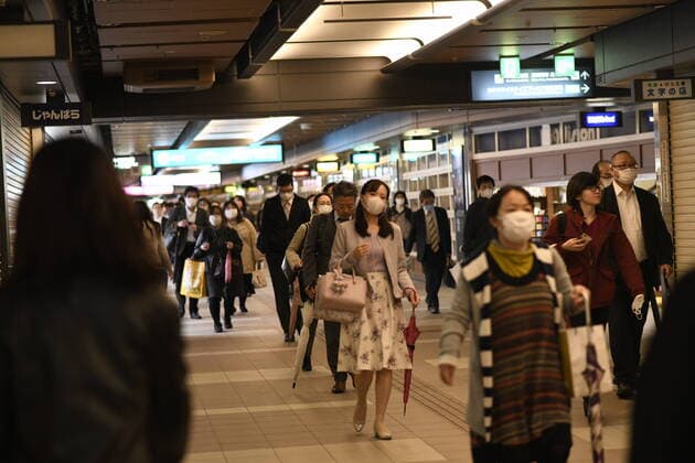 OSAKA, JAPAN - APRIL 13: Commuters wearing face mask head home near under pass of JR Central Osaka Station on Monday, April 13, 2020, amid the spread of the new coronavirus. Japanese Prime Minister Shinzo Abe declared a state of emergency last Tuesday for Tokyo and six other prefectures to ramp up defenses against the spread of the coronavirus. (Photo: Richard Atrero de Guzman AFLO)  (125303419)