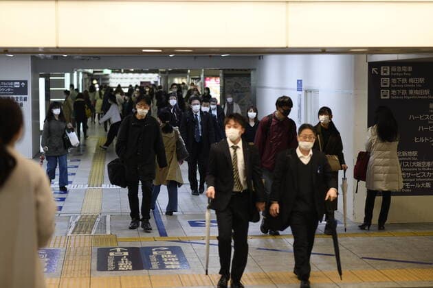 OSAKA, JAPAN - APRIL 13: Commuters wearing face mask head home near under pass of JR Central Osaka Station on Monday, April 13, 2020, amid the spread of the new coronavirus. Japanese Prime Minister Shinzo Abe declared a state of emergency last Tuesday for Tokyo and six other prefectures to ramp up defenses against the spread of the coronavirus. (Photo: Richard Atrero de Guzman AFLO)  (125303454)