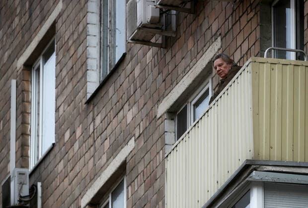 MOSCOW, RUSSIA - APRIL 13, 2020: An elderly woman on a balcony in a block of flats during the pandemic of the novel coronavirus disease (COVID-19). Moscow has been on lockdown in connection with the pandemic since 30 March 2020. At the end of March, the Russian government announced a paid period off work for employed people and school holidays, which are expected to last till the end of April. As of 12 April 2020, Russia has reported more 18,300 confirmed cases of the novel coronavirus infection, with more than 11,500 confirmed cases in Moscow. Sergei Fadeichev TASS  TS0D5948