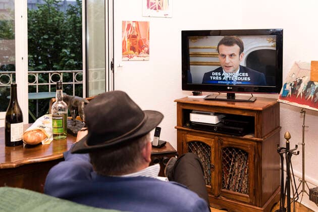 Chambery, France April 13, 2020 - A A confined French man in watching on television the speech of the French President Emmanuel Macron concerning the COVID19 health crisis ALLOCUTION, MACRON, PRESIDENT DE LA REPUBLIQUE, DISCOURS, COVID19, CRISE SANITAIRE, CONFINEMENT, SANTE, CORONAVIRUS, POLITIQUE  Copyright: xVincentxIsorex