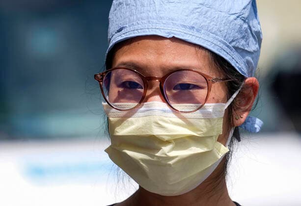 April 13, 2020, Los Angeles, California, U.S: A nurse joins other nurses and healthcare workers in a protest for the lack of personal protective equipment at UCLA Medical Center in Santa Monica, California, Monday April 13, 2020. Los Angeles U.S. - ZUMAc68_ 20200413_zaf_c68_002 Copyright: xRingoxChiux