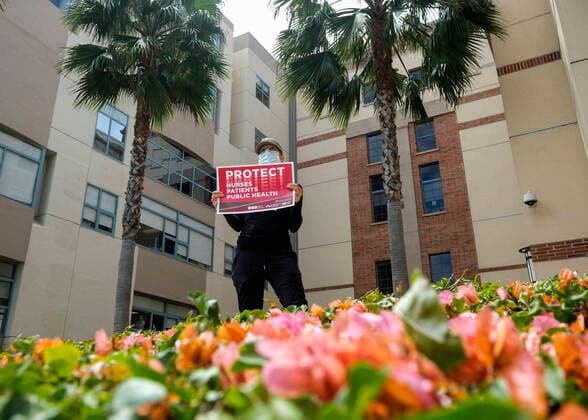 April 13, 2020, Los Angeles, California, U.S: A nurse joins other nurses and healthcare workers in a protest for the lack of personal protective equipment at UCLA Medical Center in Santa Monica, California, Monday April 13, 2020. Los Angeles U.S. - ZUMAc68_ 20200413_zaf_c68_011 Copyright: xRingoxChiux