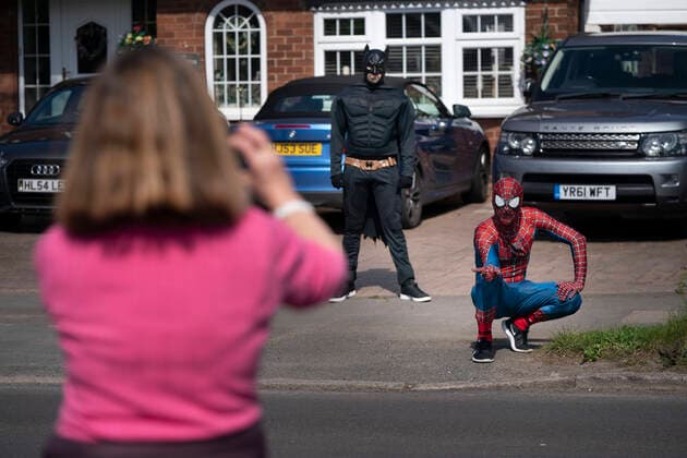 (200414) -- MANCHESTER, April 14, 2020 (Xinhua) -- Jason Baird, who runs a martial arts academy in South Manchester, dressed up as Spider-Man, entertains the public amid the COVID-19 outbreak in Manchester, Britain on April 13, 2020. (Photo by Jon Super Xinhua) BRITAIN-MANCHESTER-COVID-19-SPIDER-MAN 