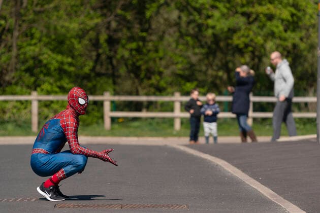 (200414) -- MANCHESTER, April 14, 2020 (Xinhua) -- Jason Baird, who runs a martial arts academy in South Manchester, dressed up as Spider-Man, entertains the public amid the COVID-19 outbreak in Manchester, Britain on April 13, 2020. (Photo by Jon Super Xinhua) BRITAIN-MANCHESTER-COVID-19-SPIDER-MAN 