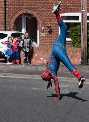 (200414) -- MANCHESTER, April 14, 2020 (Xinhua) -- Jason Baird, who runs a martial arts academy in South Manchester, dressed up as Spider-Man, entertains the public amid the COVID-19 outbreak in Manchester, Britain on April 13, 2020. (Photo by Jon Super Xinhua) BRITAIN-MANCHESTER-COVID-19-SPIDER-MAN 