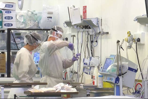 LOMBARDY, ITALY â€“ APRIL 14, 2020: Staff members at work in a field hospital in Bergamo where Russian medics join their Italian counterparts in treating coronavirus patients, 31 of them already admitted for treatment, eight cured of the COVID-19 infection. Russian Defence Ministry TASS  TS0D599E
