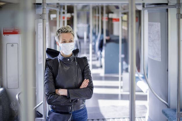 Eine Frau steht in einer S-Bahn der Berliner Verkehrsbetriebe. Sie traegt einen Mundschutz. Berlin, 13.04.2020. Aktuell denkt man in Deutschland ueber die Lockerung der Schutzmassnahmen gegen die Ausbreitung des Coronavirus nach. Eine Option koennte sein, dass Fahrgaeste Schutzmasken tragen, wenn sie den oeffentlichen Nahverkehr nutzen. Berlin Deutschland