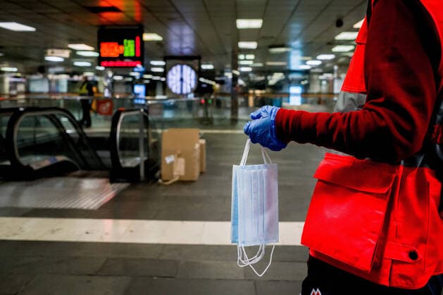 April 14, 2020, Barcelona, Catalonia, Spain: A Red Cross volunteer holds protective face masks to distribute among commuters at Catalunya station in Barcelona. Thousands of people are returning to work after the Spanish government has lift the strictest measures of coronavirus confinement. Barcelona Spain - ZUMAb137 20200414_zap_b137_010 Copyright: xJordixBoixareux