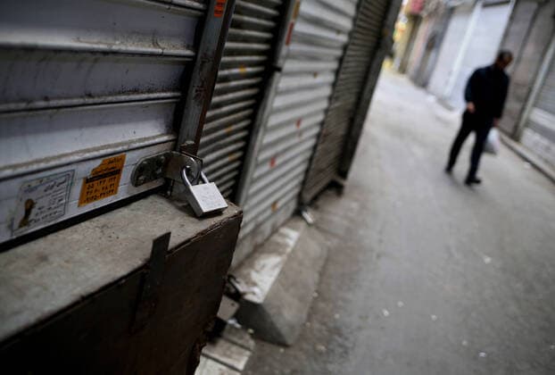 (200414) -- TEHRAN, April 14, 2020 -- A man walks past closed shops at the Grand Bazaar in Tehran, Iran, on April 13, 2020. (Photo by Xinhua) IRAN-TEHRAN-COVID-19-GRAND BAZAAR AhmadxHalabisaz 