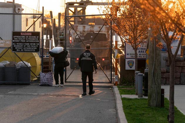 NYC buries unclaimed COVID-19 bodies on Hart Island Medical Examiner worker seen before truck is loaded on ferry from City Island to Hart Island where unclaimed COVID-19 bodies are buried New York New York United States Copyright: LevxRadin