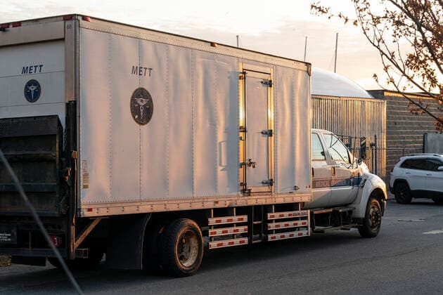 NYC buries unclaimed COVID-19 bodies on Hart Island Medical Examiner refrigerated truck seen before loaded on ferry from City Island to Hart Island where unclaimed COVID-19 bodies are buried New York New York United States Copyright: LevxRadin