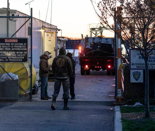 NYC buries unclaimed COVID-19 bodies on Hart Island Workers arrive for ferry docked at City Island before departure to Hart Island where unclaimed COVID-19 bodies are buried New York New York United States Copyright: LevxRadin