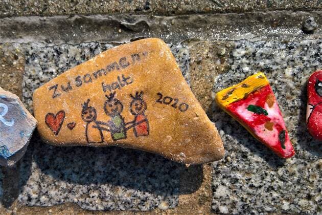 In Regensburg bemalen Kinder Kieselsteine und legen diese entlang der Donau bei Schwabelweis auf den Boden. Nach der Corona-Pandemie duerfen sich die Menschen bedienen und ihre Favoriten mit nach Hause nehmen. Foto: Bemalte Steine (Zusammenhalt 2020)