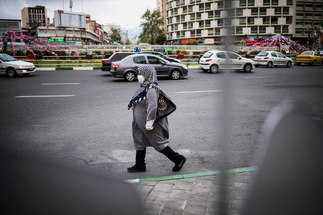 (200414) -- TEHRAN, April 14, 2020 -- A woman wearing a face mask walks on a street in Tehran, Iran, April 13, 2020. Iran registered 1,574 new COVID-19 cases over the past 24 hours, bringing the total number of confirmed cases to 74,877, according to Iran s health ministry on Tuesday. (Photo by Xinhua) IRAN-TEHRAN-COVID-19-CASES AhmadxHalabisaz 