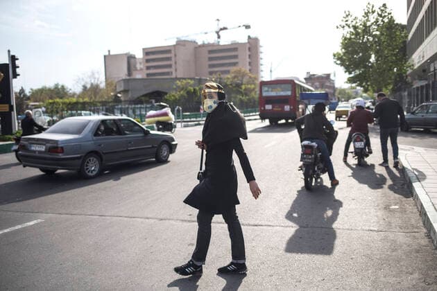 (200414) -- TEHRAN, April 14, 2020 -- A woman wearing face mask crosses a street in Tehran, Iran, April 13, 2020. Iran registered 1,574 new COVID-19 cases over the past 24 hours, bringing the total number of confirmed cases to 74,877, according to Iran s health ministry on Tuesday. (Photo by Xinhua) IRAN-TEHRAN-COVID-19-CASES AhmadxHalabisaz 