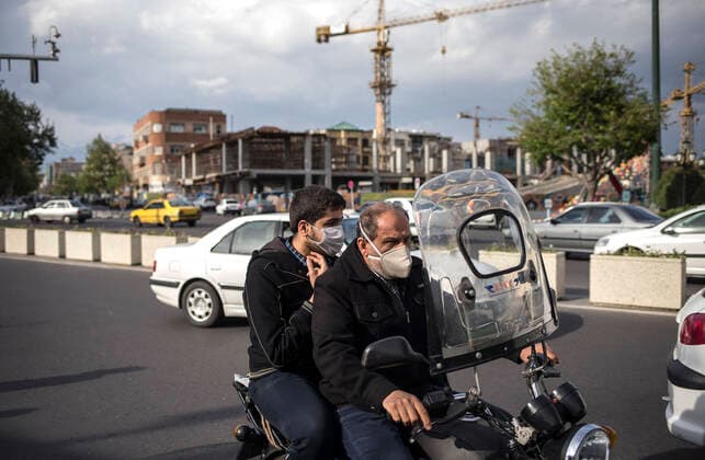 (200414) -- TEHRAN, April 14, 2020 -- People wearing face masks ride a motorbike on a street in Tehran, Iran, April 13, 2020. Iran registered 1,574 new COVID-19 cases over the past 24 hours, bringing the total number of confirmed cases to 74,877, according to Iran s health ministry on Tuesday. (Photo by Xinhua) IRAN-TEHRAN-COVID-19-CASES AhmadxHalabisaz 